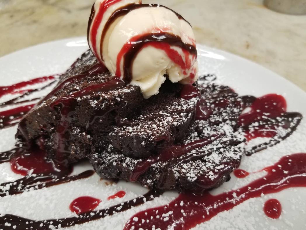 A plate topped with chocolate cake and ice cream.
