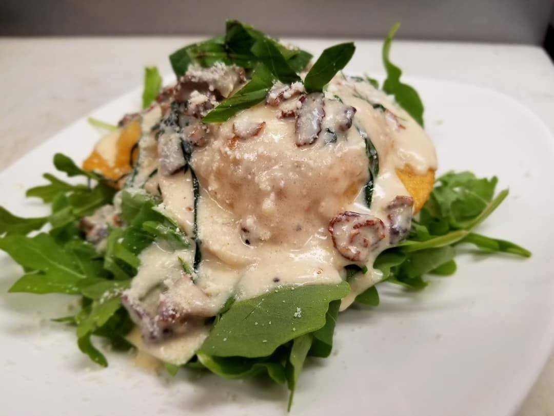 A white plate with a salad on it.