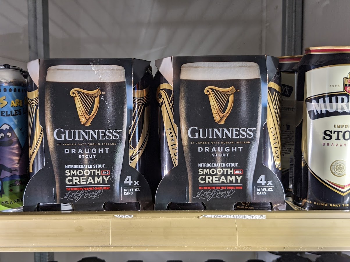 Guinness beers on a shelf in a store.