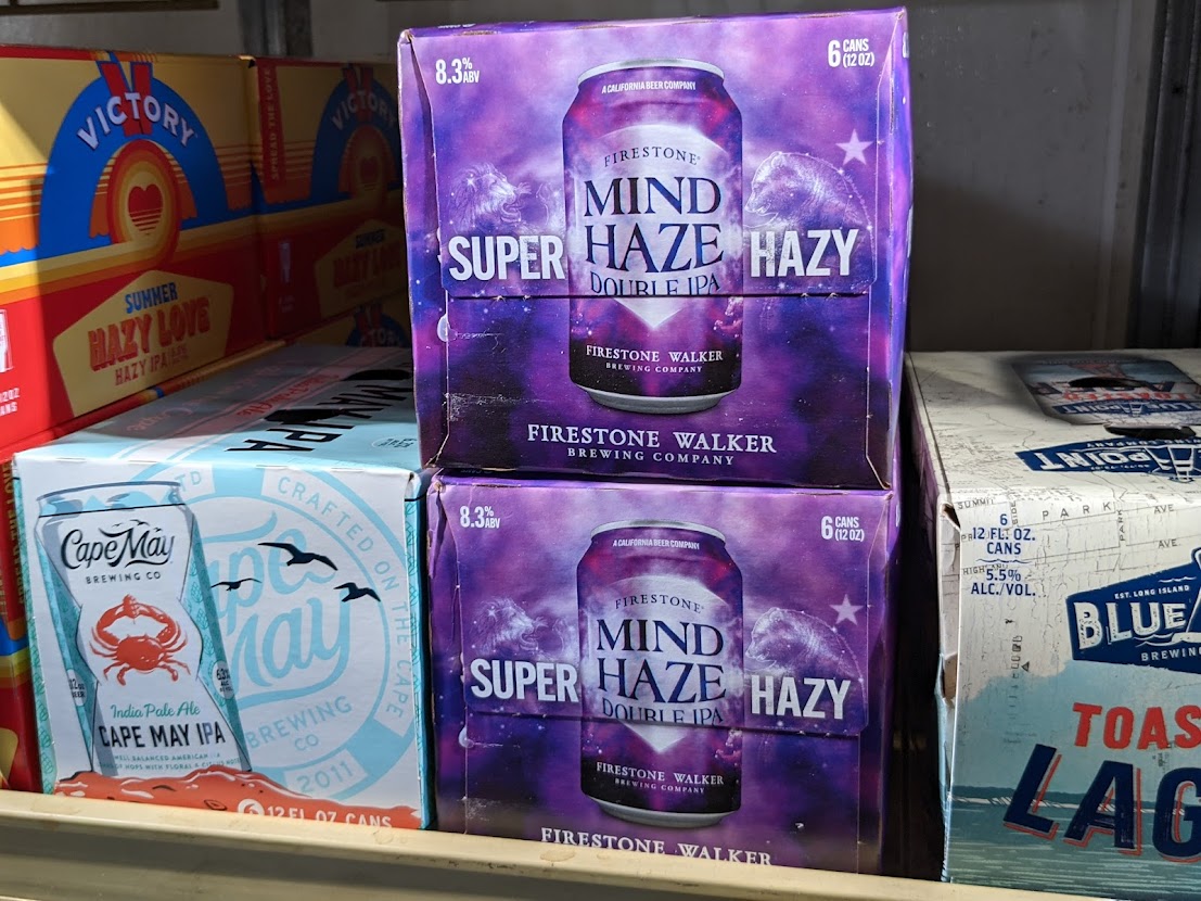 Two boxes of mind super hazy beer on a shelf.