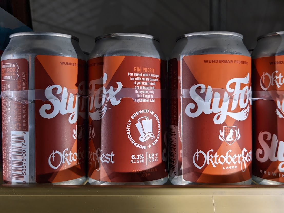 Four cans of slyfox octoberfest on a shelf.